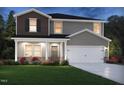 Two-story home with brown and gray siding, covered porch, attached two-car garage, landscaping, and well-manicured green lawn at 591 White Birch Ln, Angier, NC 27501