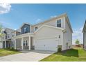Inviting exterior view of a two-story home, showcasing the attached two-car garage and front yard at 591 White Birch Ln, Angier, NC 27501