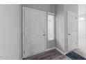 Entryway with a white door, light gray walls, and wood-look flooring at 6001 Winterpointe Ln # 204, Raleigh, NC 27606