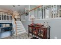 Inviting entryway featuring light gray walls, wooden railings, and decorative accents at 6089 Joe Trail Ct, Mebane, NC 27302