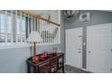 Entryway showing light gray walls, wooden railings and doors leading to backyard at 6089 Joe Trail Ct, Mebane, NC 27302