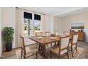 Bright dining room features wood table and chairs, large window with curtains, and hardwood floors at 65 Hickory Run Ln, Franklinton, NC 27525