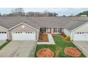 Inviting single-story home featuring an attached garage, manicured lawn, and a welcoming front entrance at 653 Huntingdon St, Elon, NC 27244