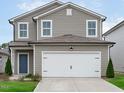 Charming two-story home with a gray exterior, white trim, and an attached two-car garage at 656 Dallas Rose Dr, Wendell, NC 27591
