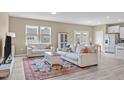 Open-concept living room featuring neutral tones, stylish furniture, and abundant natural light at 656 Dallas Rose Dr, Wendell, NC 27591