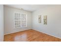 Cozy bedroom with hardwood floors, a large window, and neutral paint, creating a relaxing atmosphere at 7533 Silver View Ln, Raleigh, NC 27613