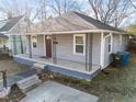 Inviting one-story home showcasing a cozy front porch with decorative iron supports at 805 N Elizabeth St St, Durham, NC 27701
