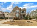 Charming two-story brick home with a well-manicured lawn and inviting curb appeal at 8304 Rosiere Dr, Cary, NC 27518