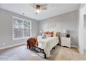 Cozy bedroom featuring a ceiling fan, neutral tones, and a large window for natural light at 833 Providence Glen Dr, Chapel Hill, NC 27514