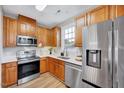 Well-equipped kitchen featuring stainless steel appliances, light countertops, and wood-stained cabinetry at 833 Providence Glen Dr, Chapel Hill, NC 27514