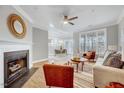Inviting living room with fireplace, stylish decor, and an adjacent dining area and abundant natural light at 833 Providence Glen Dr, Chapel Hill, NC 27514