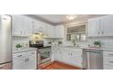 Well-lit kitchen featuring white cabinets, stainless steel appliances, and a window view at 918 Templeridge Rd, Wake Forest, NC 27587