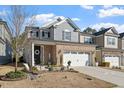 Charming two-story home with brick accents, a well-manicured lawn, and an attached two-car garage at 938 Haybeck Ln, Apex, NC 27523
