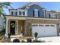 Charming two-story home featuring a brick facade, two-car garage, and well-maintained landscaping at 938 Haybeck Ln, Apex, NC 27523
