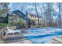View of covered pool with home and sunroom in background at 94 Cedar Hills Cir, Chapel Hill, NC 27514