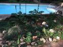 The pool is surrounded by plants and garden decor at 94 Cedar Hills Cir, Chapel Hill, NC 27514
