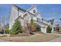 Well-maintained two-story home showing manicured yard, stone-accented porch, and neutral color palette at 100 Highveld Ave, Chapel Hill, NC 27516