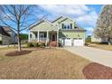Inviting two-story home with a spacious front yard, charming porch, and convenient two-car garage at 1024 Jensen Grove Ct, Fuquay Varina, NC 27526