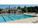Resort-style community pool with lounge chairs and well maintained brick building at 105 Olde Liberty Dr, Youngsville, NC 27596