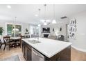 Modern open-concept featuring a large island, stainless steel appliances, hardwood floors, and an open dining/living area at 105 Olde Liberty Dr, Youngsville, NC 27596