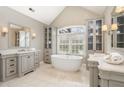 Elegant bathroom with a standalone tub, large window, and custom vanities for a spa-like retreat at 116 Galway Dr, Chapel Hill, NC 27517