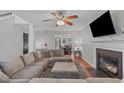 Inviting living room with a fireplace, plush sectional, and open dining area with natural light at 117 Talley Ridge Dr, Holly Springs, NC 27540