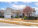 Lovely single-story home featuring a two-car garage and beautiful landscaping at 1214 Gaston Manor Dr, Durham, NC 27703