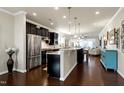 Modern kitchen with stainless steel appliances, dark cabinets, and a spacious center island at 1407 Palmer Hill Dr, Durham, NC 27703