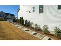 Sloping backyard features a stepped walkway, landscaped garden beds, and lush greenery at 1532 Champlain Crest Way, Cary, NC 27513