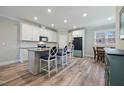 Bright kitchen with white cabinets, granite counters, stainless steel appliances, and a central island at 169 Black Cloud Dr, Louisburg, NC 27549