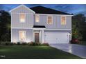 Charming two-story home featuring gray siding, a front-entry two-car garage, and a well-manicured lawn at 18 Thistle Patch Pl, Angier, NC 27501