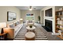 Staged living room showcasing neutral colors, fireplace, and sliding glass doors at 2013 Turtle Point Dr, Raleigh, NC 27604