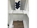 A selection of bathroom tile samples including wood, dark herringbone, and white cabinets at 239 Meadowbark Bnd # 27, Garner, NC 27529