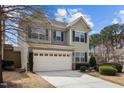 Two-story home featuring a two-car garage and neutral-colored exterior with well-maintained landscaping at 241 Westgrove Ct, Durham, NC 27703