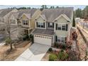 Two-story home featuring a two-car garage and neutral-colored exterior with well-maintained landscaping at 241 Westgrove Ct, Durham, NC 27703