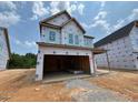 New two-story home with unfinished siding and an attached two-car garage at 243 Meadowbark Bnd # 28, Garner, NC 27529