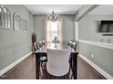 Elegant dining room with hardwood floors, modern light fixture, and decorative wall accents at 2741 Rains Dr, Haw River, NC 27258