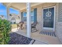 Inviting front porch features rocking chairs, a welcome mat, and a stylish front door with monogram at 2741 Rains Dr, Haw River, NC 27258