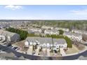 Aerial view of townhome community surrounded by lush trees and well-maintained streets at 2821 Casona Way, Raleigh, NC 27616
