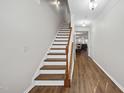 Inviting entryway with hardwood floors, staircase, and view into the living area at 2821 Casona Way, Raleigh, NC 27616
