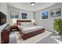 This staged primary bedroom features stylish decor and an abundance of natural light from the dual windows at 317 Gary St, Raleigh, NC 27606