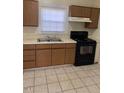 Functional kitchen with ample cabinet space, laminate counters, and an electric range at 333 Leasburg Rd, Roxboro, NC 27573