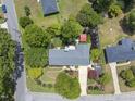 Aerial view of landscaped property showcasing the house and surrounding greenery and neighborhood at 401 Fletcher Dr, Raleigh, NC 27603