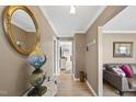 Inviting hallway with hardwood floors, neutral walls, and decorative mirror adding to the decor at 401 Fletcher Dr, Raleigh, NC 27603