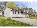 Charming single-story home with a well-maintained lawn and a classic white brick facade at 409 Avery St, Garner, NC 27529