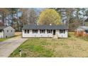 Charming single-story home with a well-maintained lawn and a classic white brick facade at 409 Avery St, Garner, NC 27529