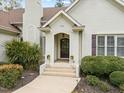 A lovely front entrance with a brick exterior, stylish door, and manicured landscaping at 5300 Mandrake Ct, Raleigh, NC 27613