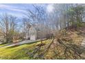 Two-story home with a two-car garage and lush green lawn in a natural setting at 6008 Chittim Ct, Raleigh, NC 27616