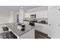 Well-equipped kitchen featuring stainless steel appliances and granite countertops at 73 Club Rd, Louisburg, NC 27549