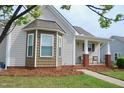 Lovely home exterior showcasing a cozy porch area, brick accents, and inviting curb appeal at 75 E Moss Creek Dr, Clayton, NC 27520